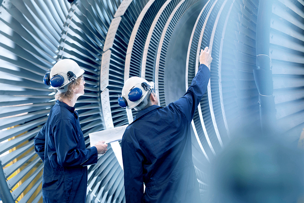 Engineers in front of power turbine